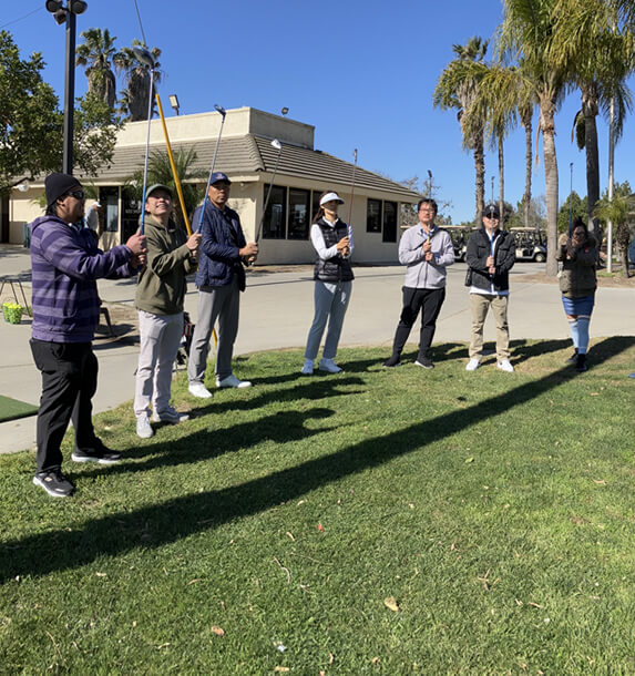 group of golfers holding their golf stick